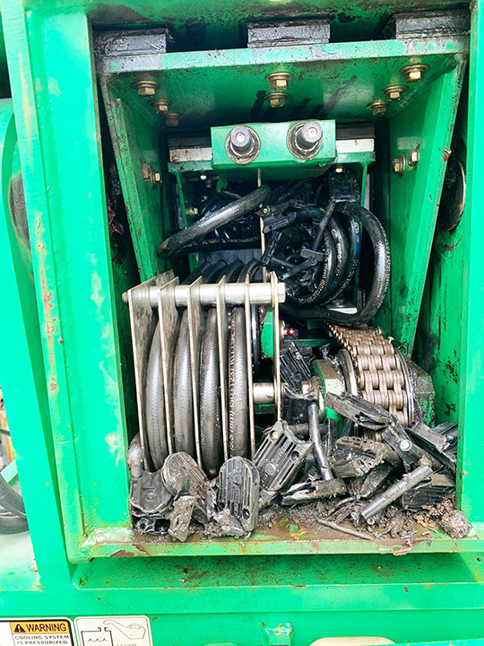 Damaged SkyTrak 10054 boom hose carrier assembly with broken carrier and damaged hoses
